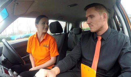 The guy teaches the girl to drive a car and have sex right there